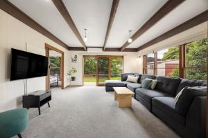 a living room with a couch and a tv at Maffra Motor Inn in Maffra