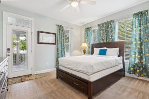 a bedroom with a bed and two windows at Sojourn Beautiful Family Home with Backyard in Ghent in Norfolk