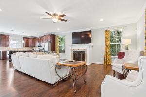 a living room with white furniture and a fireplace at Sojourn Beautiful Family Home with Backyard in Ghent in Norfolk +60 photos