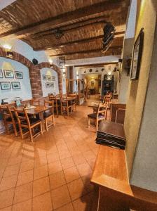 a dining room with wooden tables and chairs at Pension Vzhůru nohama in Jáchymov