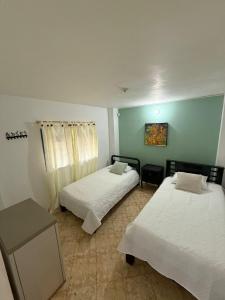 Postel nebo postele na pokoji v ubytování Encantadora finca en el corazón de Marinilla con vistas únicas y ubicación privilegiada