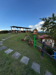 a park with a playground and a bird house at Encantadora finca en el corazón de Marinilla con vistas únicas y ubicación privilegiada in Marinilla