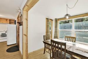 a kitchen and dining room with a table and a window at Sugar Bear Chalet #2559 in Sugarloaf