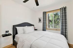 a bedroom with a large white bed and a window at Sugar Bear Chalet #2559 in Sugarloaf