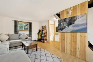 a living room with a couch and a tv at Sugar Bear Chalet #2559 in Sugarloaf