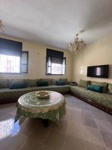 a living room with a couch and a table at Bright Self-Catering 2 bedroom Apartment in Tafraout in Tafraoute +19 photos