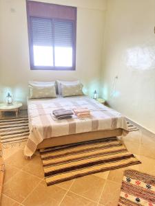 a bed in a room with a window at Bright Self-Catering 2 bedroom Apartment in Tafraout in Tafraoute