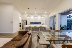 a living room with a couch and a glass table at Sandy Soles in Agnes Water