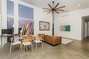 a living room with a table and chairs and a couch at Sandy Soles in Agnes Water