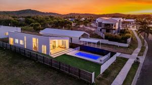 an aerial view of a house with a sunset at Sandy Soles in Agnes Water