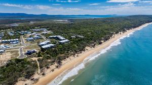 an aerial view of the beach and the ocean at Sandy Soles in Agnes Water