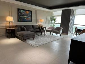 a living room with a couch and a table and chairs at 1 Constitution Avenue By Goldfinch in Islamabad +26 photos