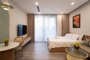 a hotel room with a bed and a television at La Vie Eco in HÆ°ng YÃªn