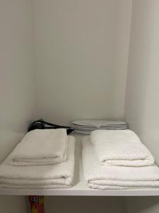 two towels on a shelf in a closet at Vibe Comfort Tirana in Tirana +6 photos