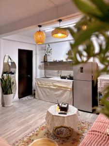 a living room with a table and a kitchen at De'Lea Homestay & Hotel in Ho Chi Minh City