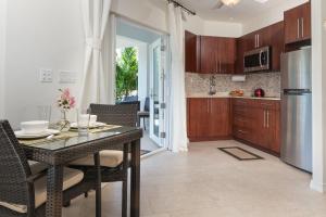 a kitchen and dining room with a table and chairs at Karana Studio 1 - K1 in Long Bay Hills +56 photos