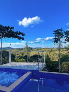 a swimming pool with a view of a field at Villa Verde in Popayan