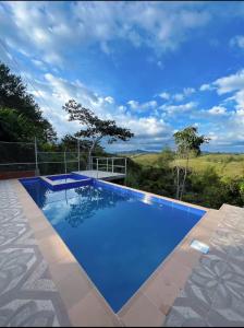a large blue swimming pool with a view at Villa Verde in Popayan