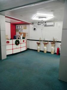 a large room with white cabinets and green carpet at 999 Hotel in Angeles