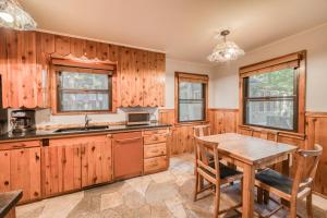 a kitchen with wooden cabinets and a wooden table at Diana's Cabin by Tahoe Getaways - Pet-Friendly 2BR in Kings Beach w Backyard & Walk to Lake! in Wood Vista