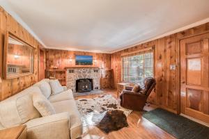 a living room with a couch and a fireplace at Diana's Cabin by Tahoe Getaways - Pet-Friendly 2BR in Kings Beach w Backyard & Walk to Lake! in Wood Vista