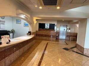 a waiting room with a counter and a television at プリンスプラージュ沖縄301 in Onna