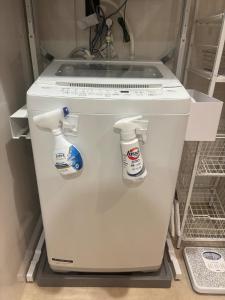 a white refrigerator with two bottles of bleach at プリンスプラージュ沖縄301 in Onna