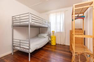 a bedroom with a bunk bed and a ladder at Pippis a Classic Beach House in Seal Rocks