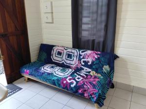 a couch sitting in the corner of a room at Bungalow Dumonter in Baie-Mahault