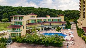 a building with a swimming pool and a resort at Perla Sun Beach Hotel - All Inclusive in Primorsko