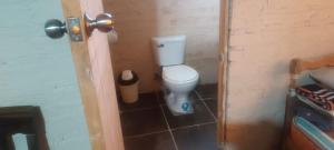 a bathroom with a white toilet in a room at Cozy Rural House in Apata - Jauja  +11 photos