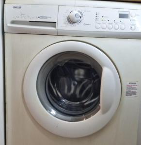 a washing machine with its door open at La Cámara de El Cristo in Oviedo +2 photos