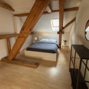 a bedroom with a bed in a attic at Aussergewöhnliche Loft Wohnung mit Hängenetzen und Schaukeln in Frauenfeld