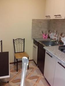 a kitchen with a sink and a chair in it at Name in Tʼelavi +9 photos