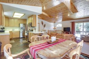 a kitchen and dining room with a wooden table and chairs at 7 Mi to Northstar Resort Tahoe Vista Family Cabin in Tahoe Vista