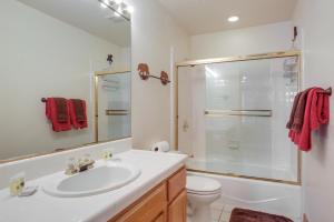 a bathroom with a sink and a toilet and a shower at 7 Mi to Northstar Resort Tahoe Vista Family Cabin in Tahoe Vista +19 photos