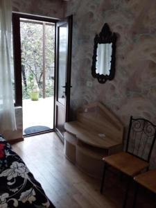 a bedroom with a bed and a mirror on the wall at Name in Tʼelavi