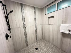a shower stall in a bathroom with a window at Unit 3 Waena Inn Newly Renovated Maui Private Suite in Wailuku +1 photo