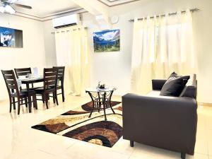a living room with a couch and a table at Luxury GuestHouse Suites in Cap-Haïtien