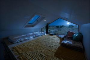 a living room with a couch and a large window at Luxury Tiny House with Private Hot Tub Access at the Grand Canyon in Valle +5 photos