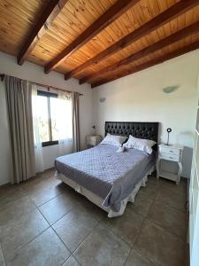 a bedroom with a bed and a wooden ceiling at Refugio de las Nubes in Las Rabonas