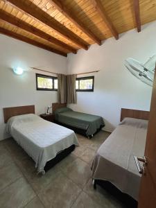 a room with two beds and two windows at Refugio de las Nubes in Las Rabonas +15 photos