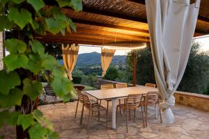 a wooden table and chairs on a patio at Stone Villa Overlooking Panicale Vineyards in Panicale