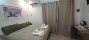 a hotel room with two towels on a bed at GR Hotel in La Rioja