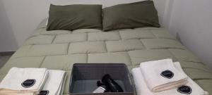 a bed with towels and a phone on it at GR Hotel in La Rioja