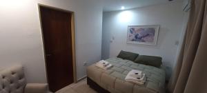 a small bedroom with a bed and a mirror at GR Hotel in La Rioja