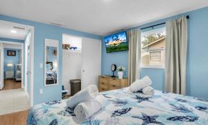 a blue bedroom with a bed with white pillows at Peaceful Family Getaway in Venice in Venice