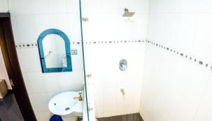 a bathroom with a sink and a mirror at Kings Apartment Ikeja in Ikeja