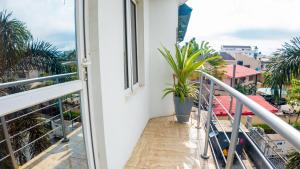 a balcony with a potted plant and a window at Kings Apartment Ikeja in Ikeja