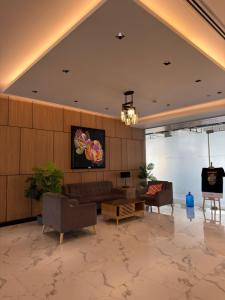 a living room with a couch and chairs and a tv at Cliffiens Cozy Space in Sampong